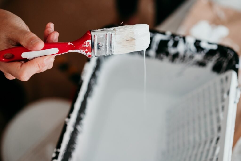 woman painting the room walls with white color. Do it yourself and new home